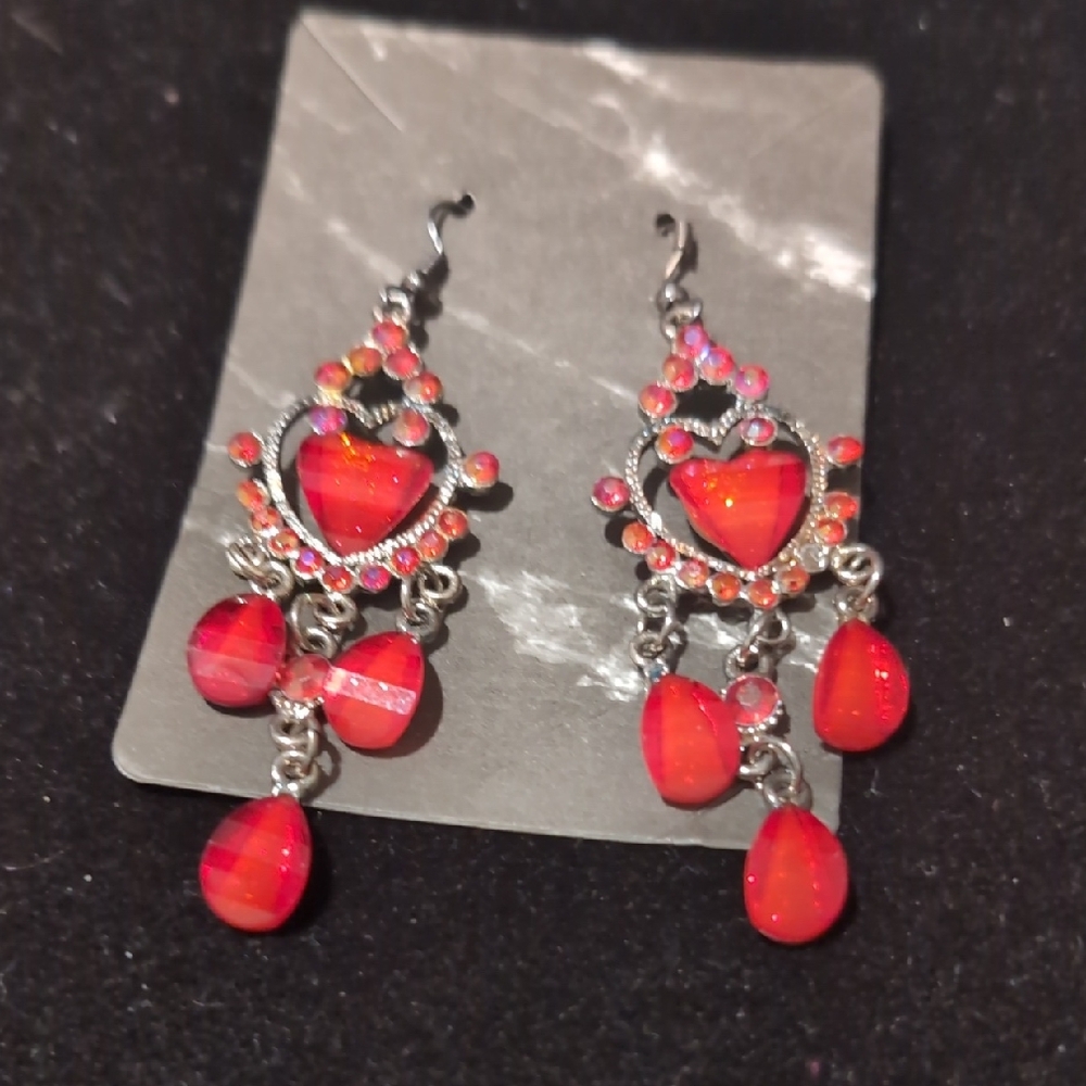 silver-toned dangle earrings featuring red heart-shaped stones and red teardrop